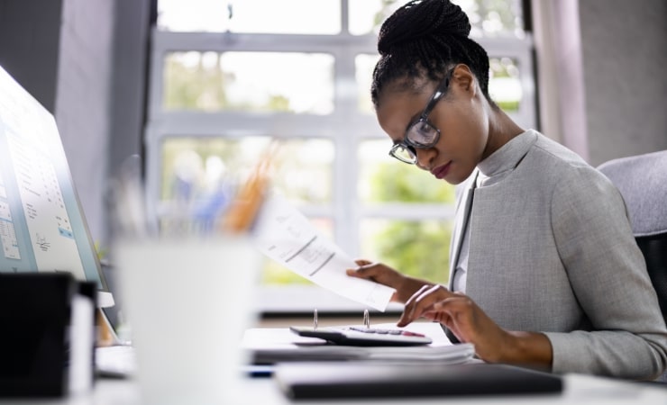 A woman doing auditing work using calculator