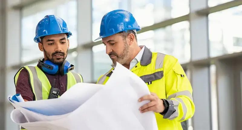 Two engineers looking at a plan