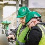 People in construction looking at a laptop