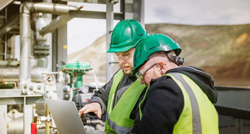 People in construction looking at a laptop