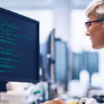 A computer programmer working on new software in the office